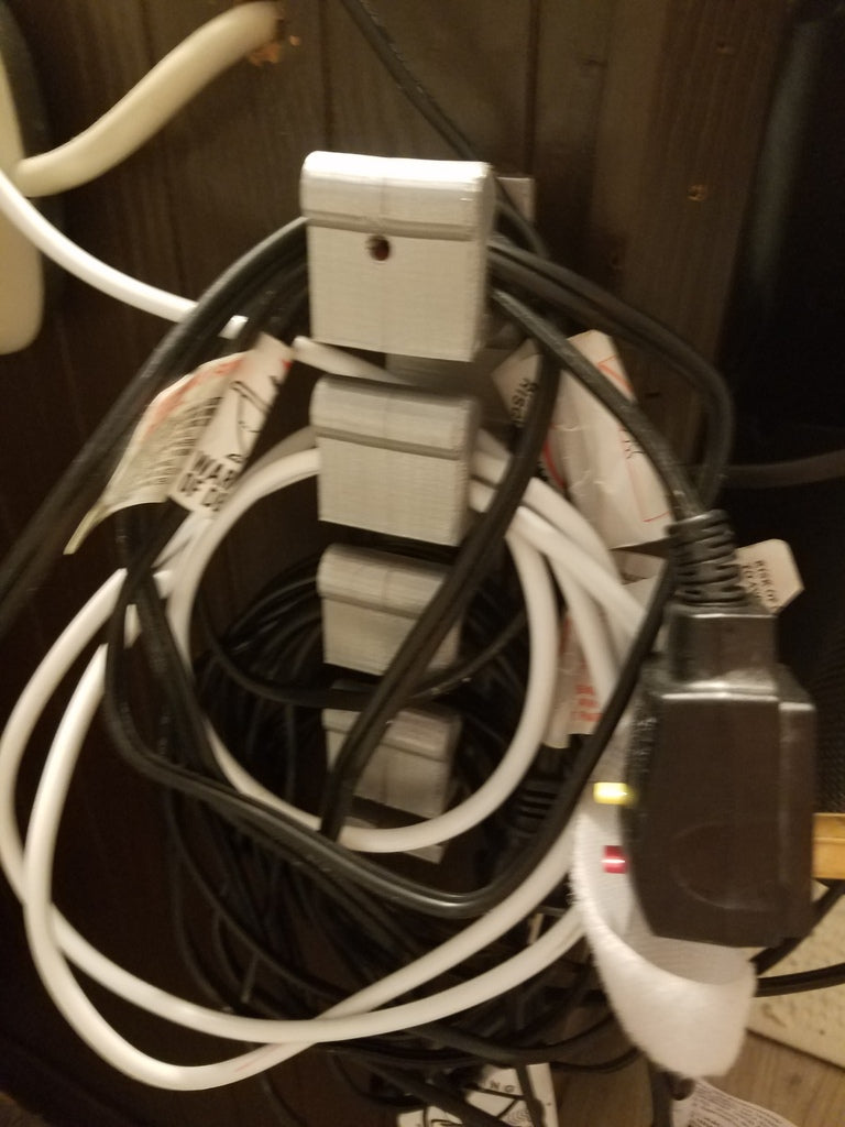 Wall-mounted cable holder
