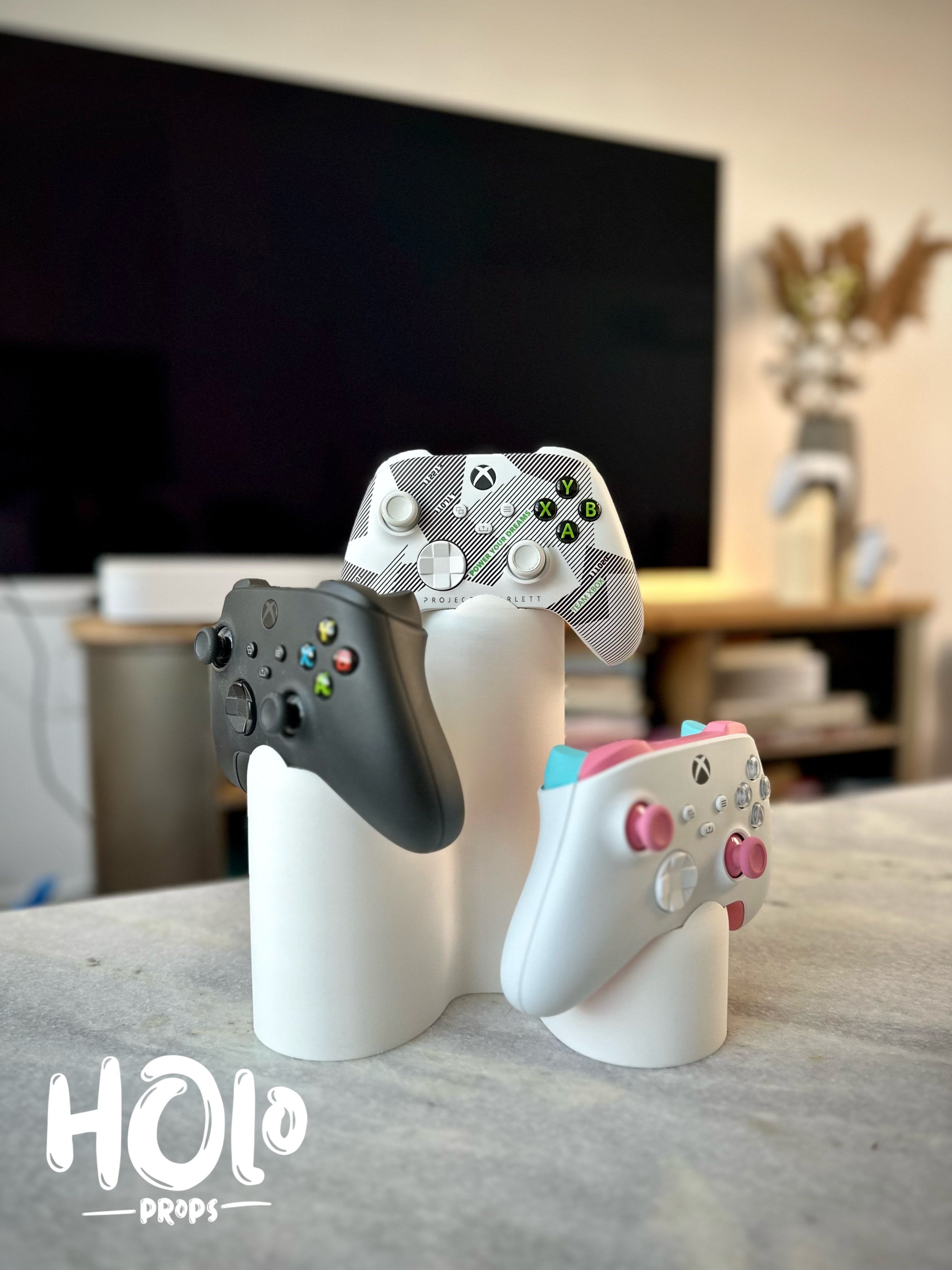 Modern stand for three PlayStation Xbox controllers