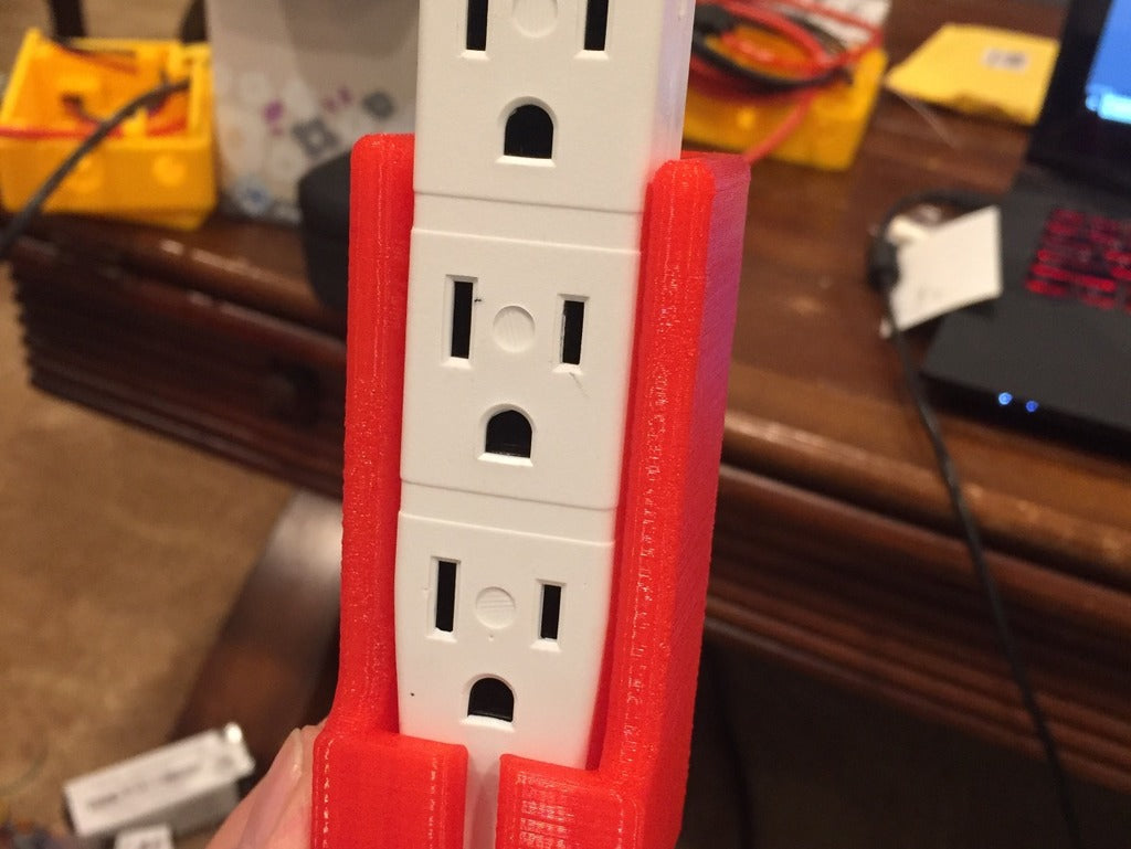 Wall-mounted extension lead holder