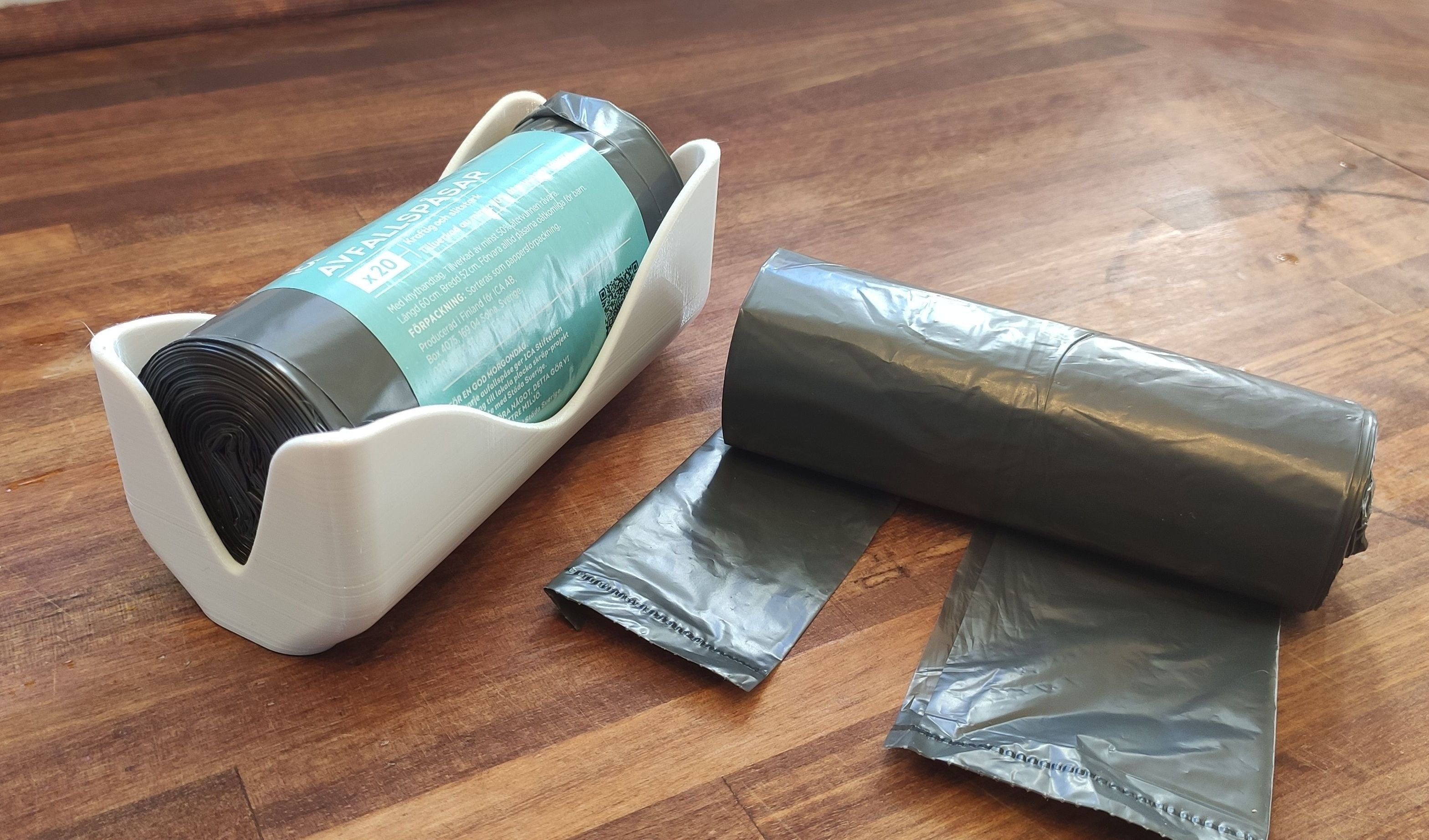 Wall-mounted bin bag holder