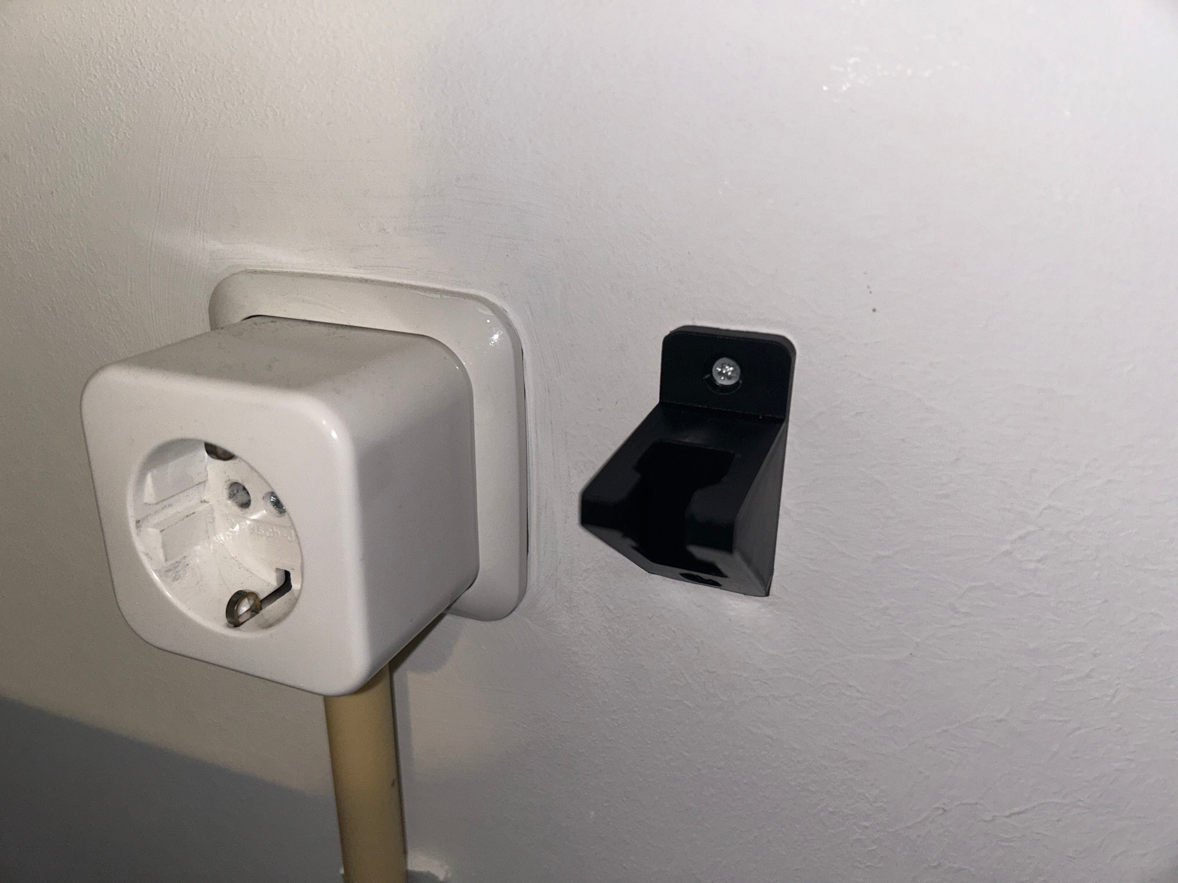 Wall-mounted power cord holder
