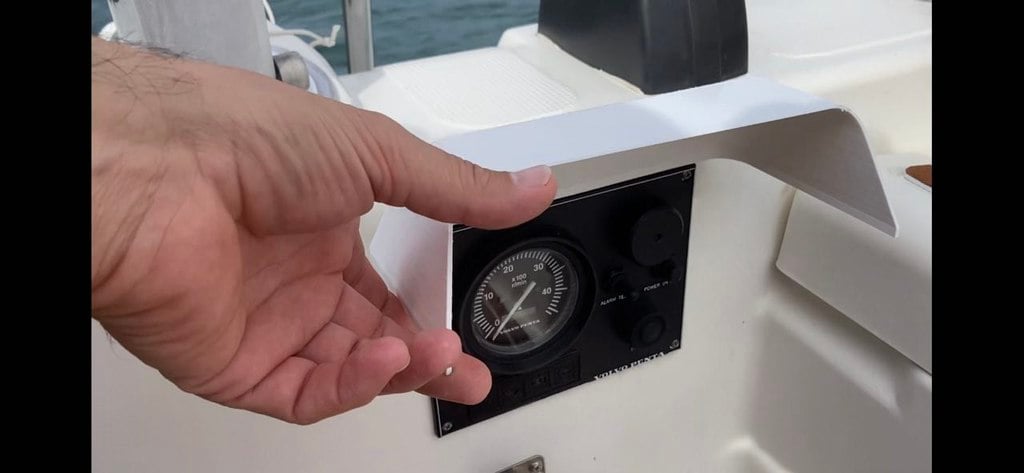 Cover with hinge for panel on boat engine