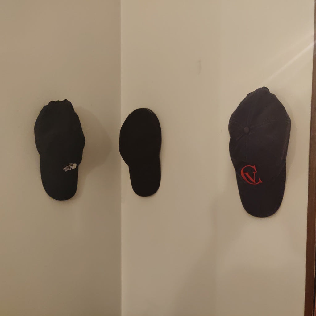 Wall mounted cap holder