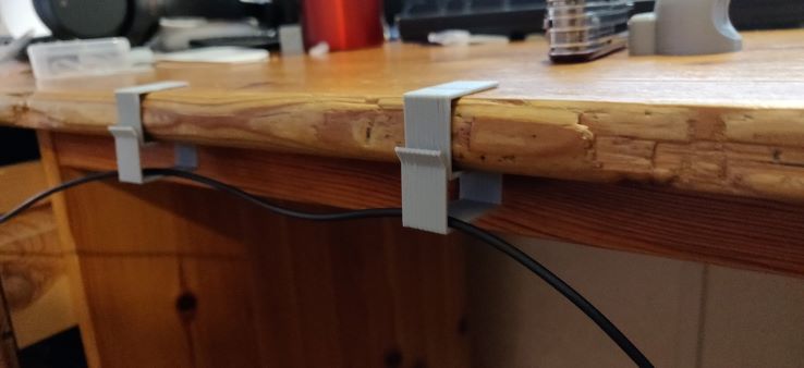 Cable management clips for desk and shelf