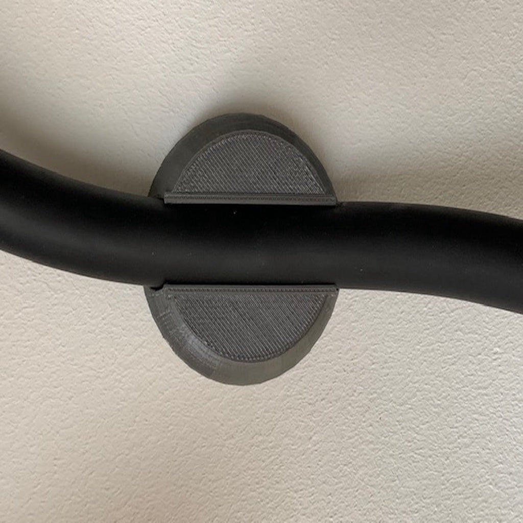 Wall-mounted click holder for 19 mm cable for electric car charger