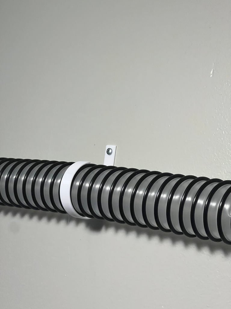 Wall-mounted holder for 2-inch vacuum hose
