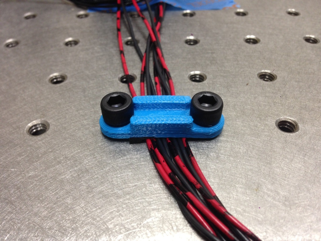 Cable clamp for optical tables