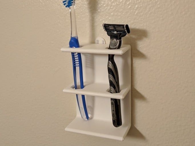 Wall-mounted holder for toothbrush or shaver