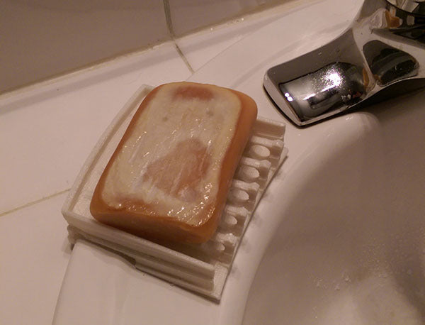 Soap dispenser for the edge of the sink