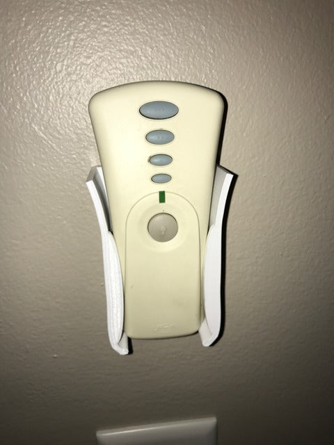 Wall-mounted holder for ceiling fan remote control