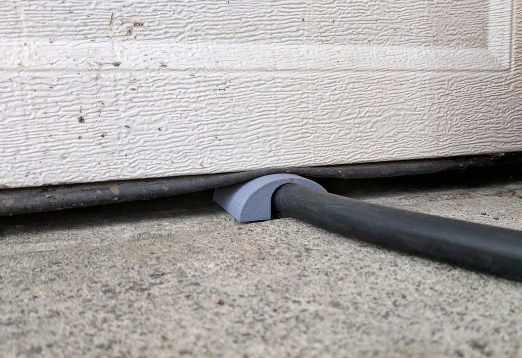 Garage door pass for EV charging cable
