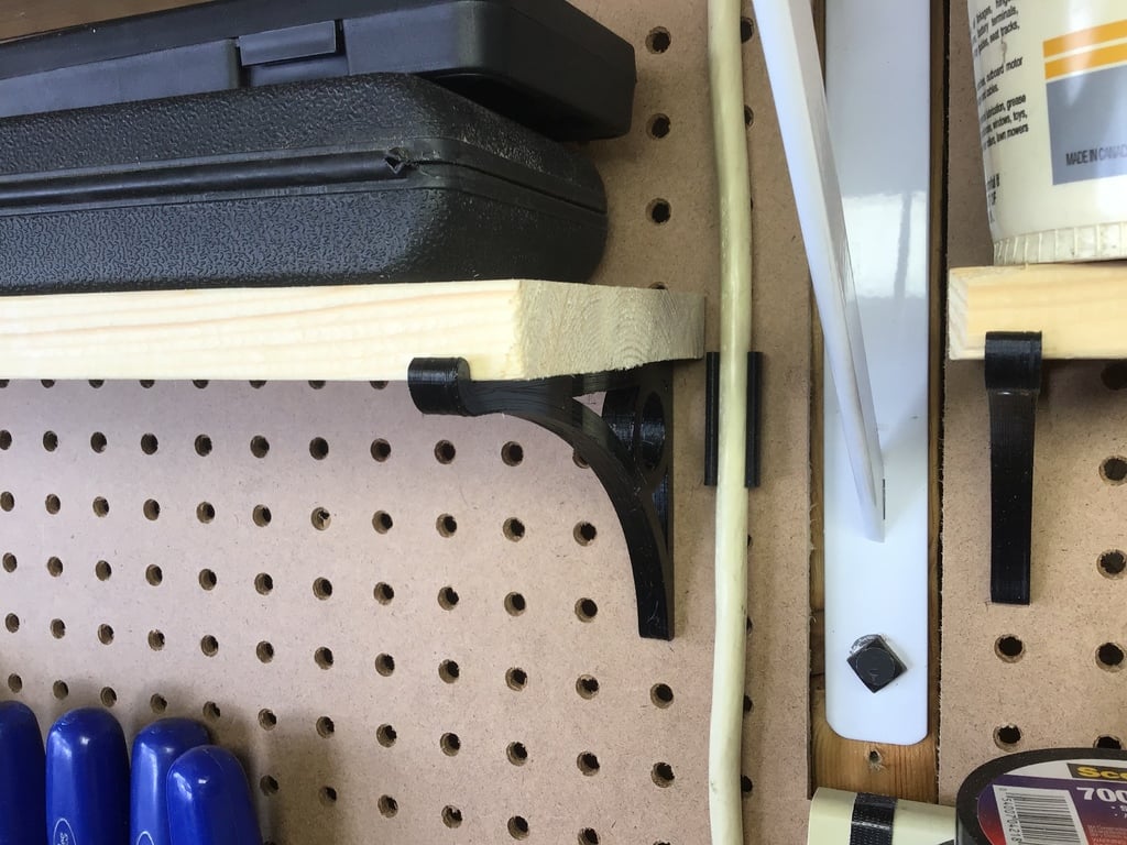 Several clamps and brackets for 1/4 inch Pegboard