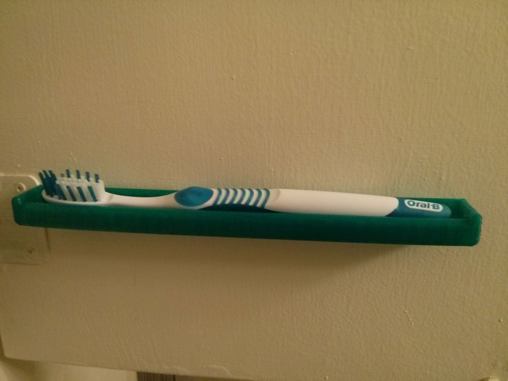 Space-saving toothbrush holder