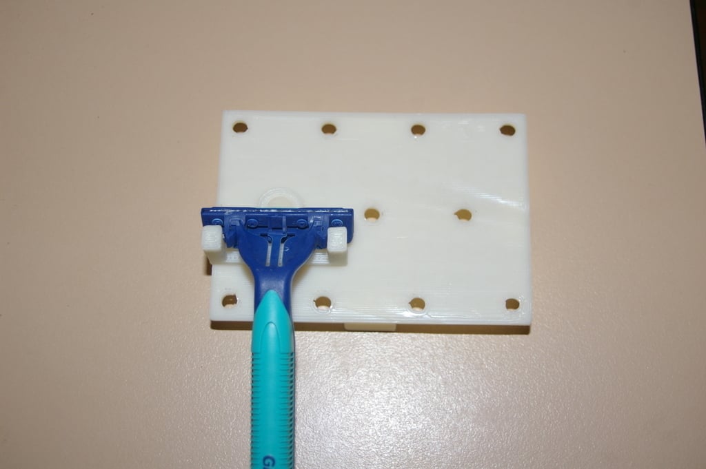 Disposable razor blade holder for wall or mini pegboard
