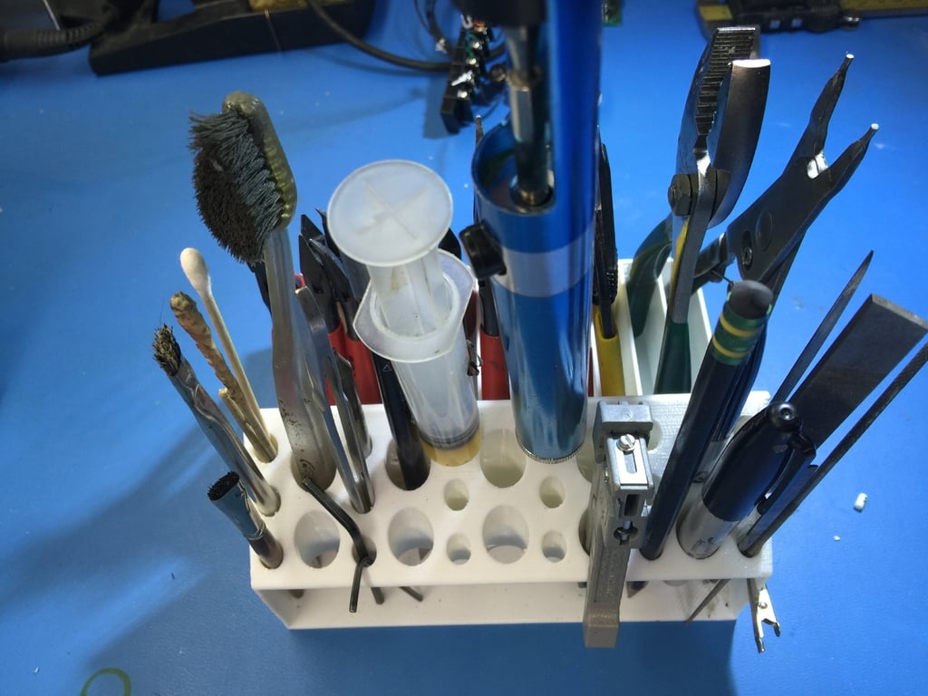 Tool holder for small pliers with holes for screwdrivers