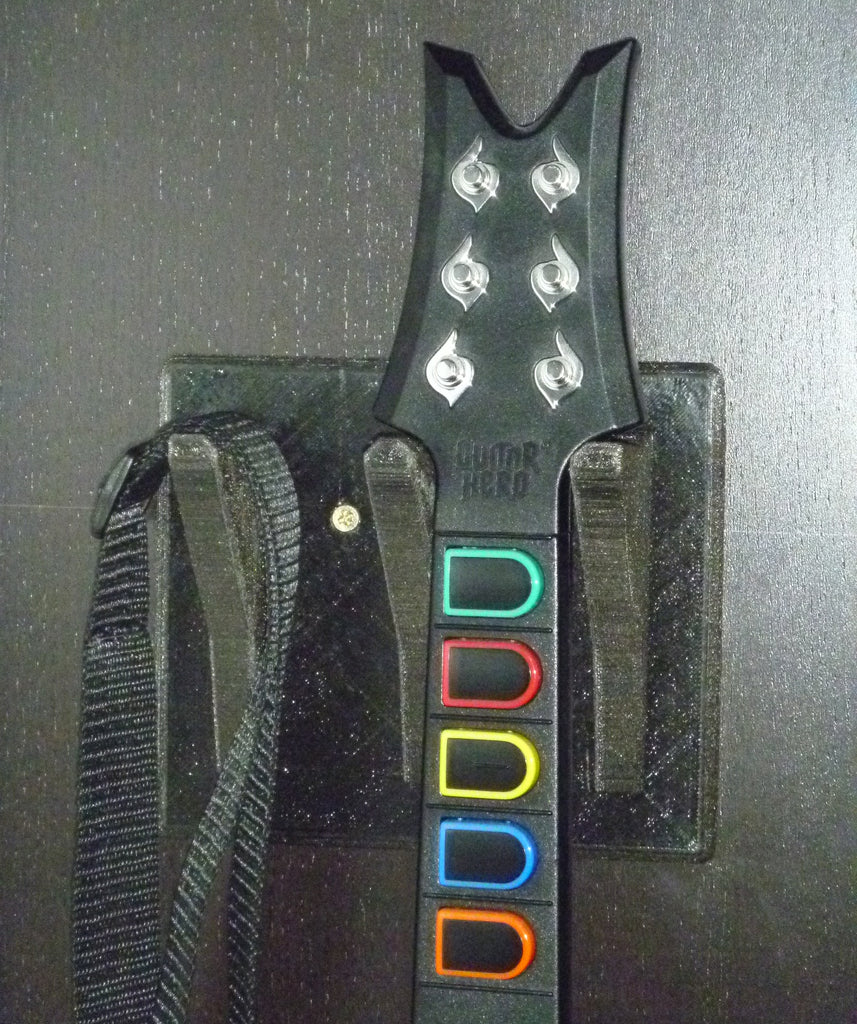 Wall mounted holder for Guitar Hero with extra hook for strap