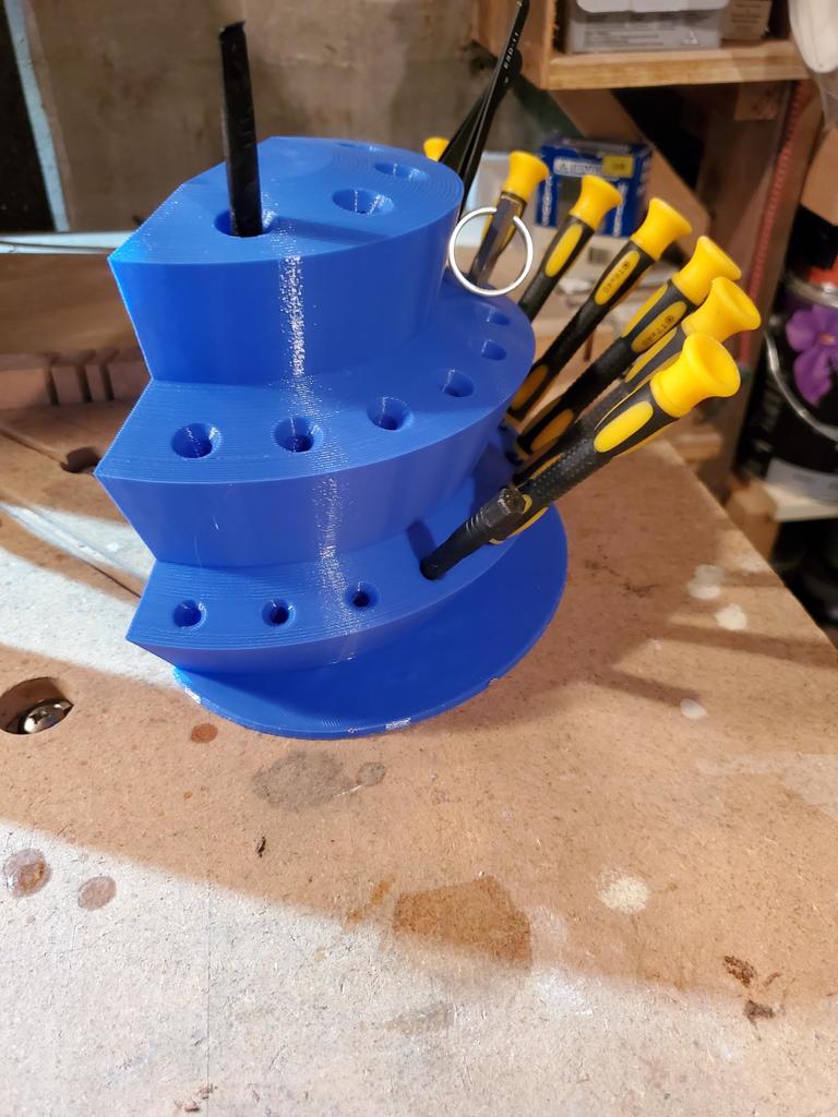 Wall or table stand for screwdriver with foot attachment