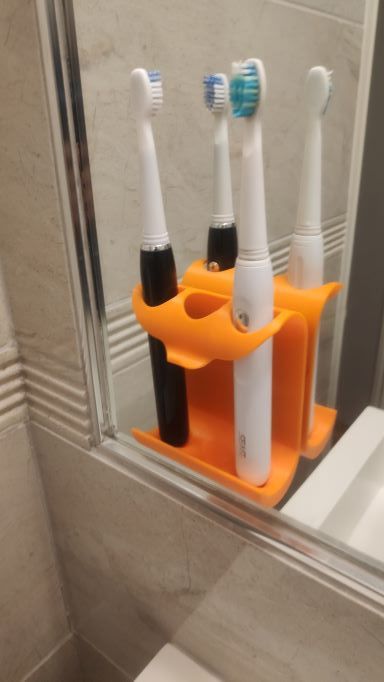 Wall holder and toothpaste squeezer for toothbrush