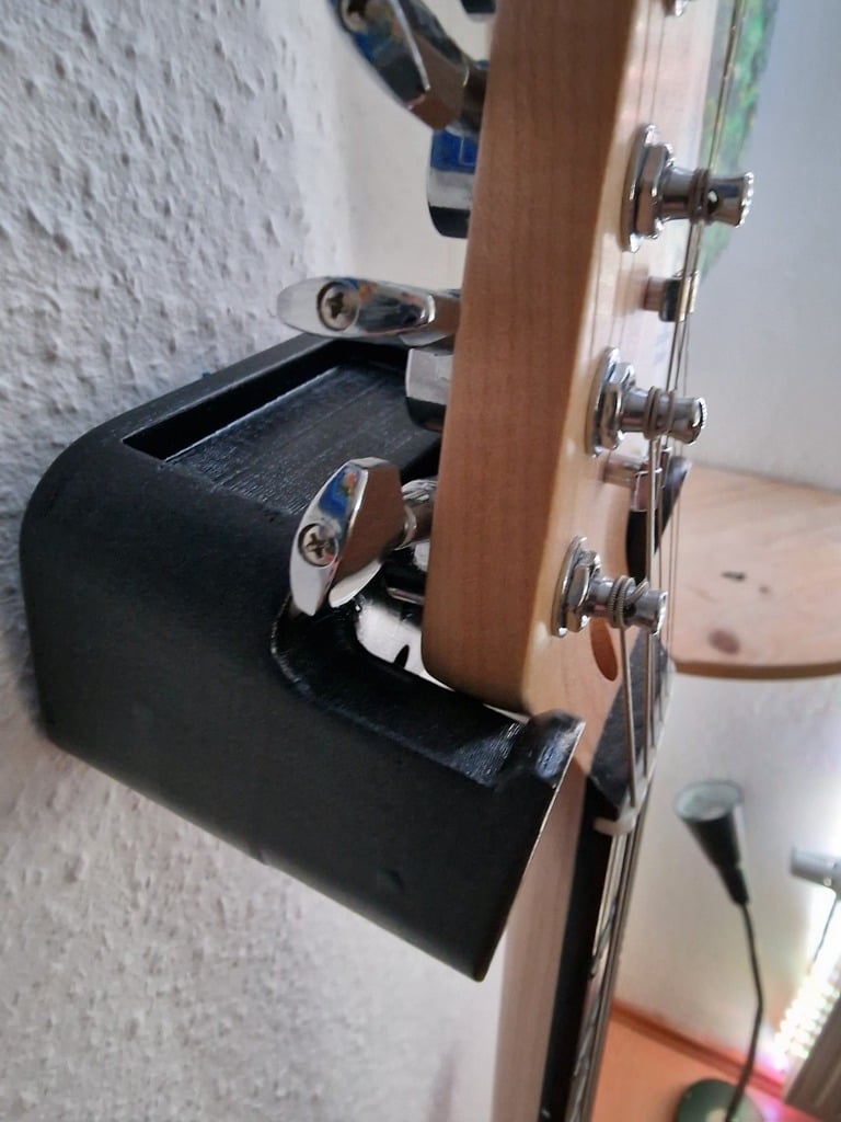 Guitar hanger with space for plectrums