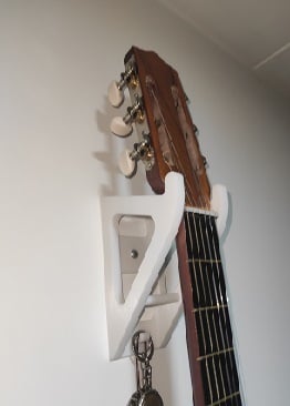 Wall base for hanging guitar
