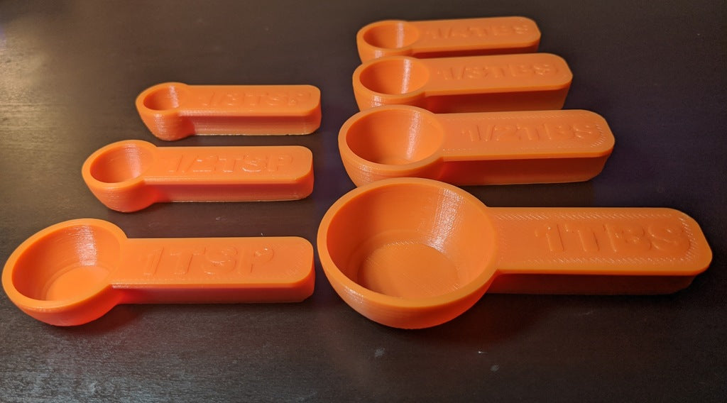 Measuring spoons with magnetic mounts for easy cleaning and fridge storage