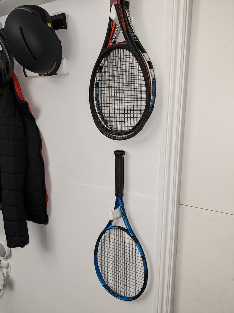 Wall-mounted tennis racket holder
